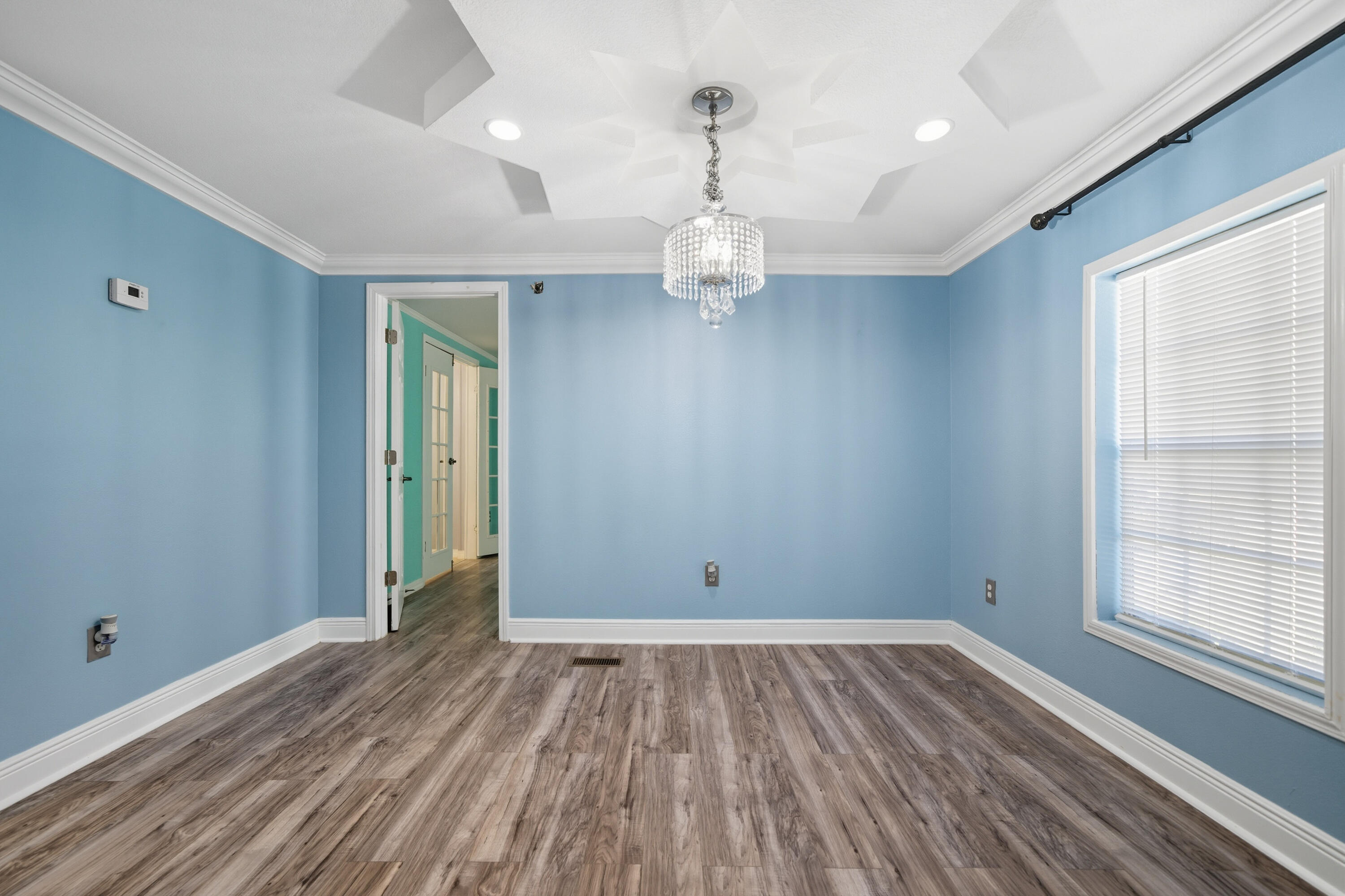 714 East Picasso Road DeFuniak Springs, FL 32433 - Photo 16 of 25 wooden floor in an empty room with a window