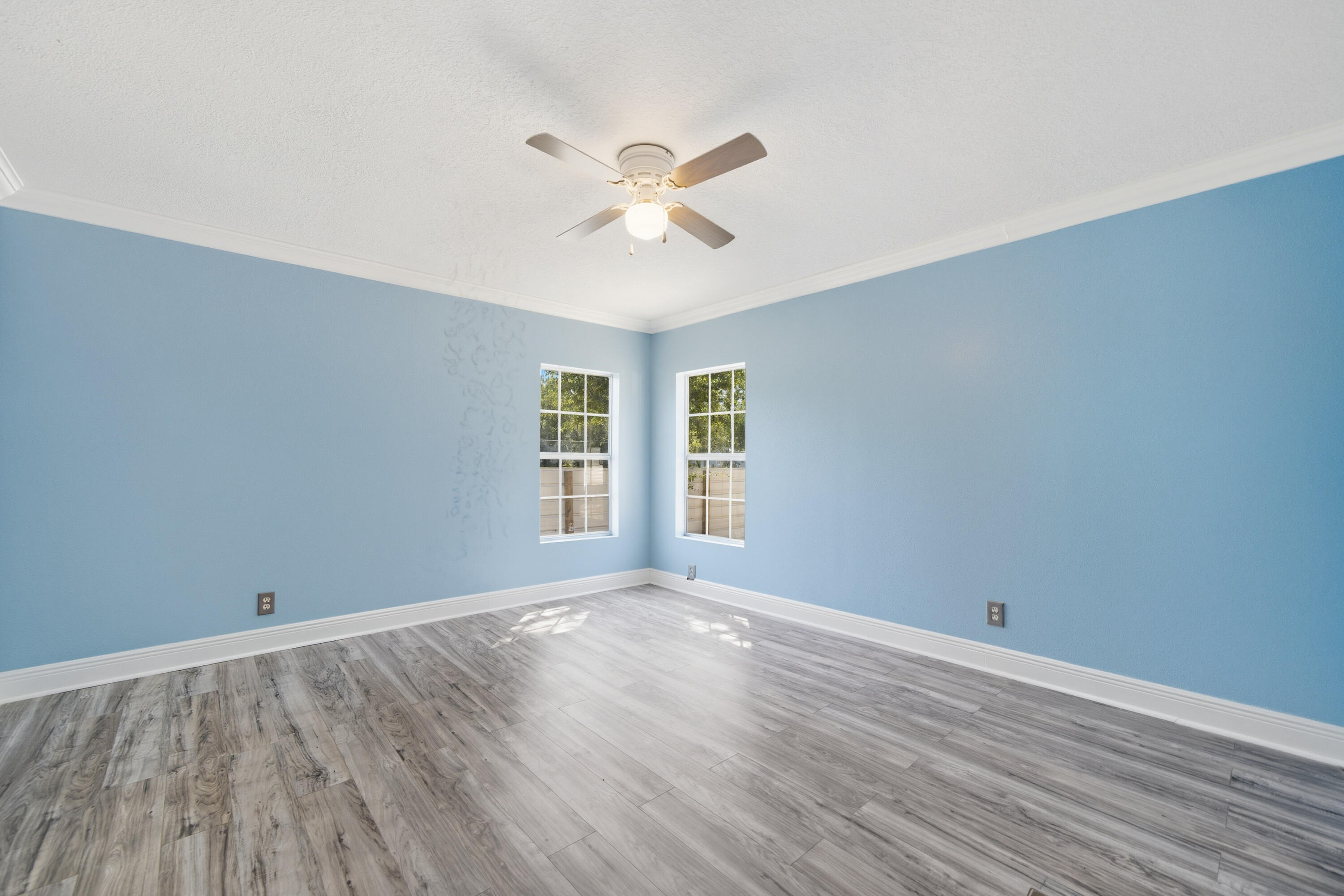 714 East Picasso Road DeFuniak Springs, FL 32433 - Photo 17 of 25 a view of empty room with wooden floor and fan