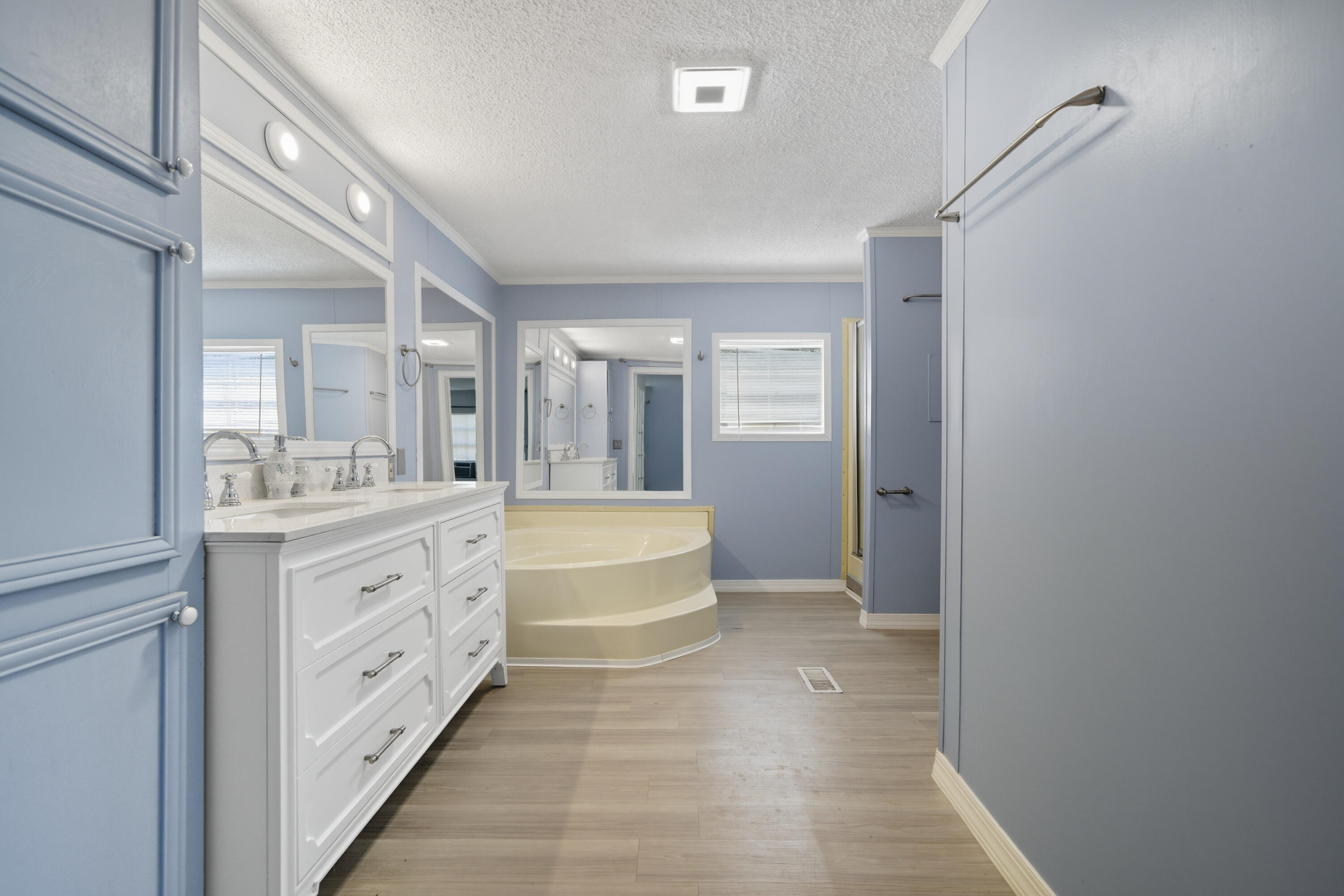 714 East Picasso Road DeFuniak Springs, FL 32433 - Photo 20 of 25 a spacious bathroom with a granite countertop sink a mirror and a bathtub