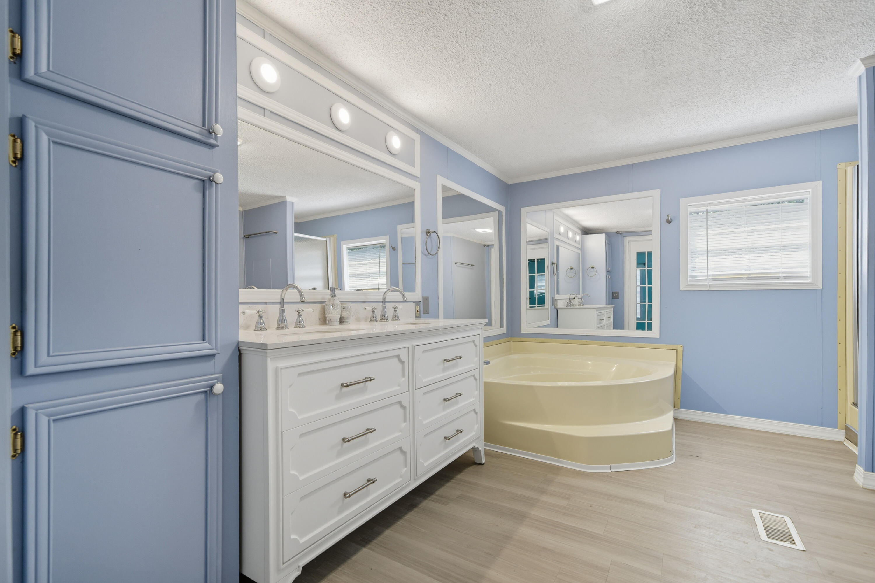 714 East Picasso Road DeFuniak Springs, FL 32433 - Photo 21 of 25 a spacious bathroom with a tub sink and a mirror