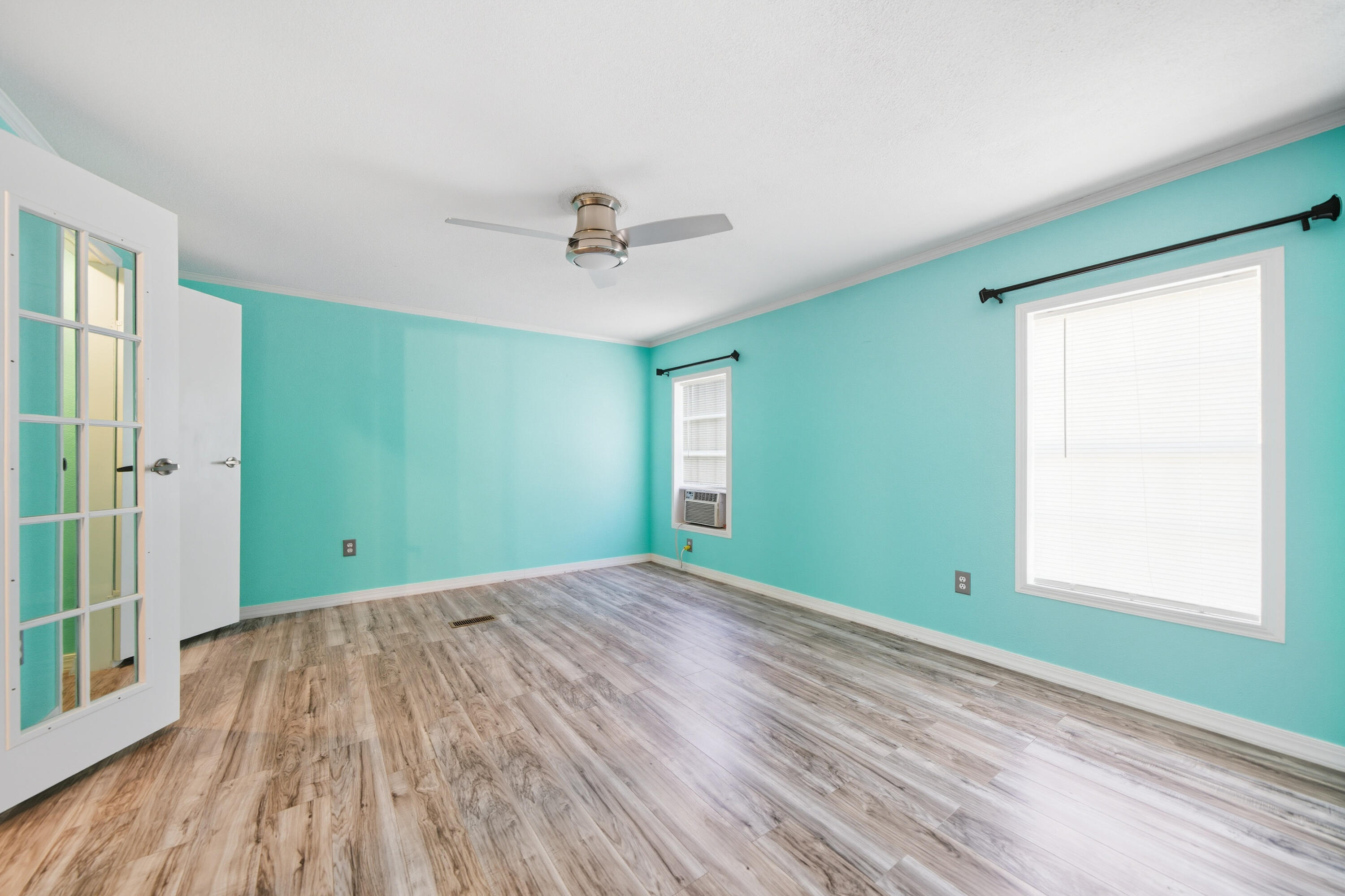 714 East Picasso Road DeFuniak Springs, FL 32433 - Photo 23 of 25 a view of an empty room with wooden floor and a window