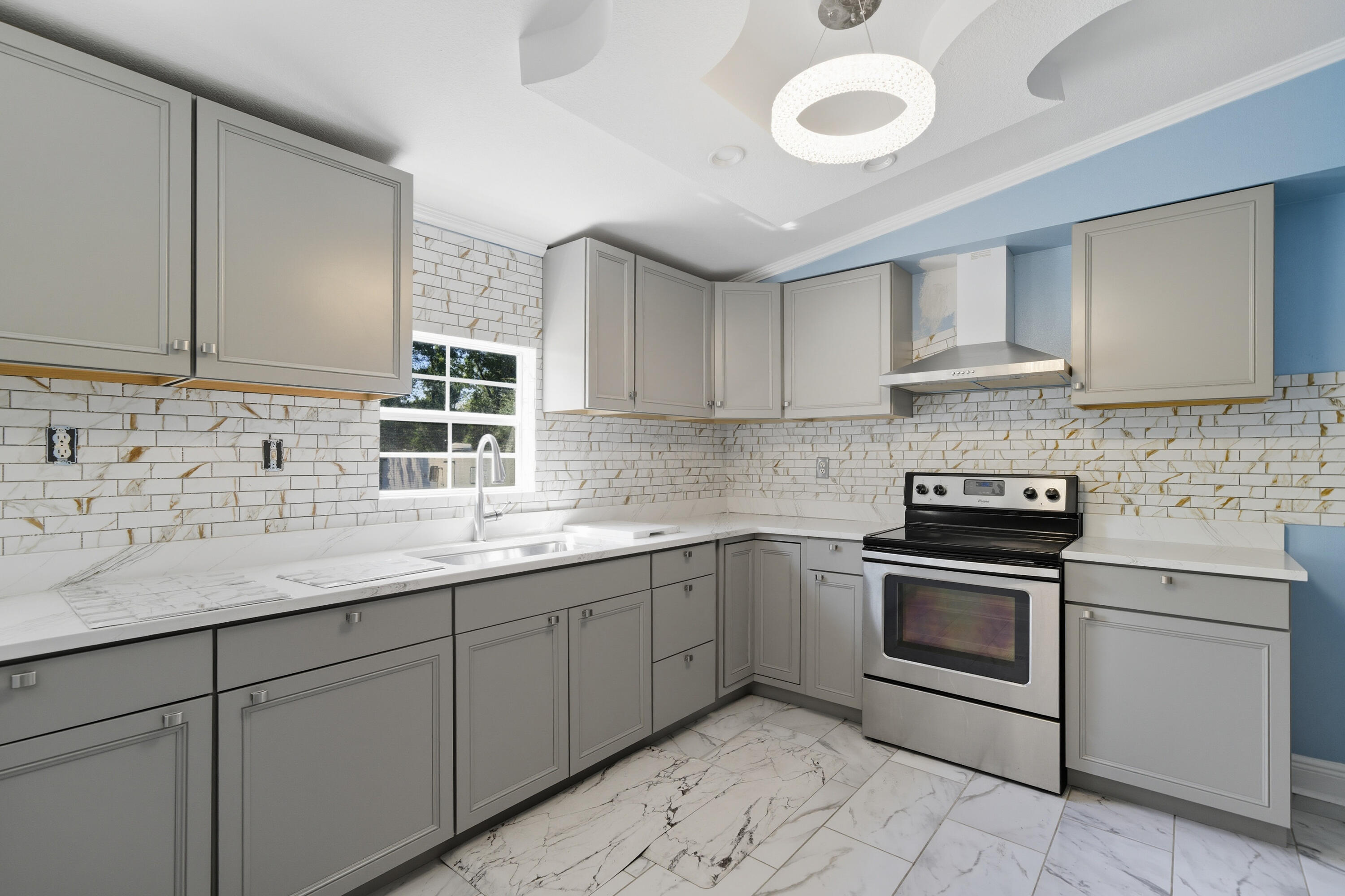 714 East Picasso Road DeFuniak Springs, FL 32433 - Photo 7 of 25 a kitchen with stainless steel appliances granite countertop a sink stove and cabinets