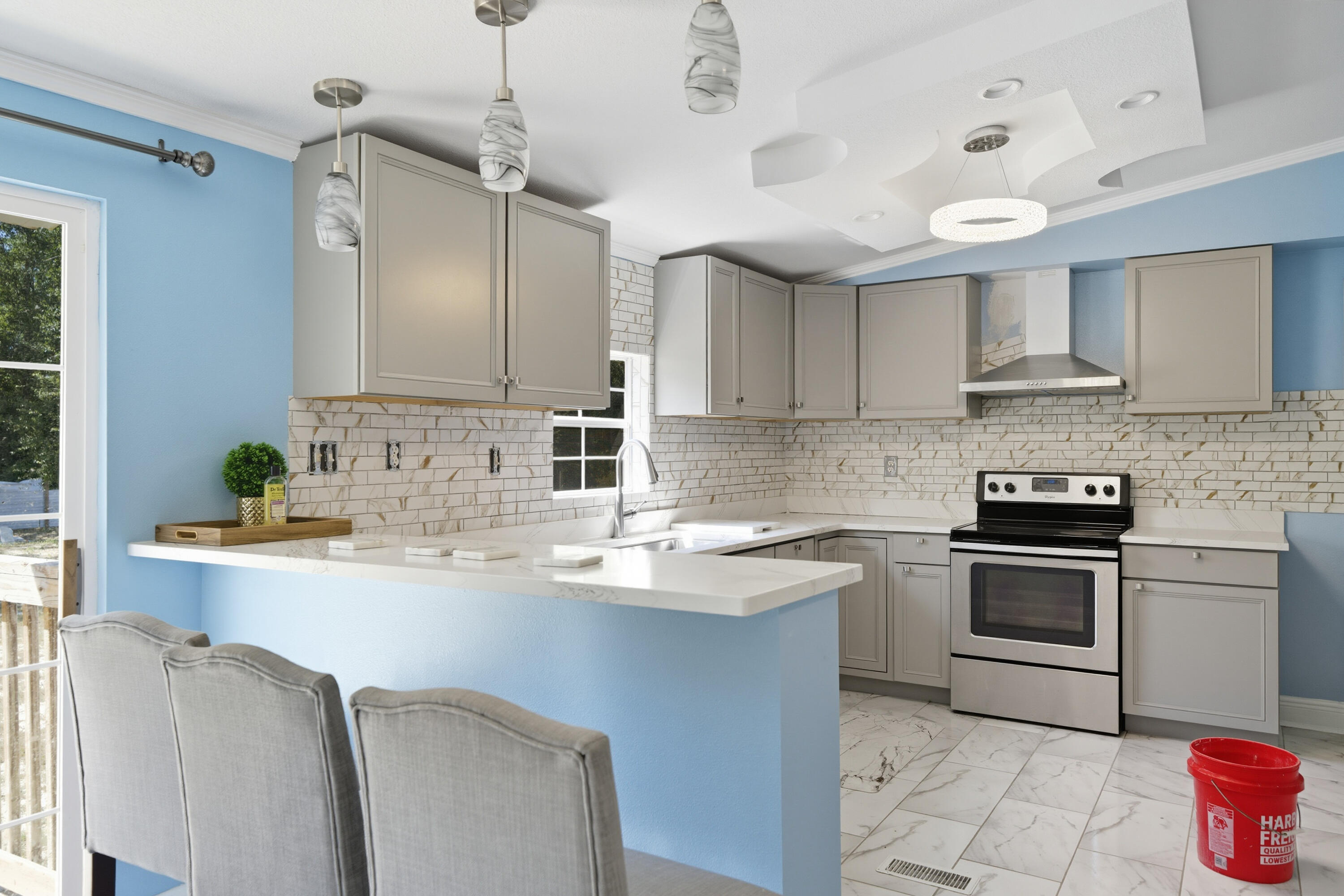 714 East Picasso Road DeFuniak Springs, FL 32433 - Photo 9 of 25 a kitchen with granite countertop a sink stainless steel appliances and cabinets