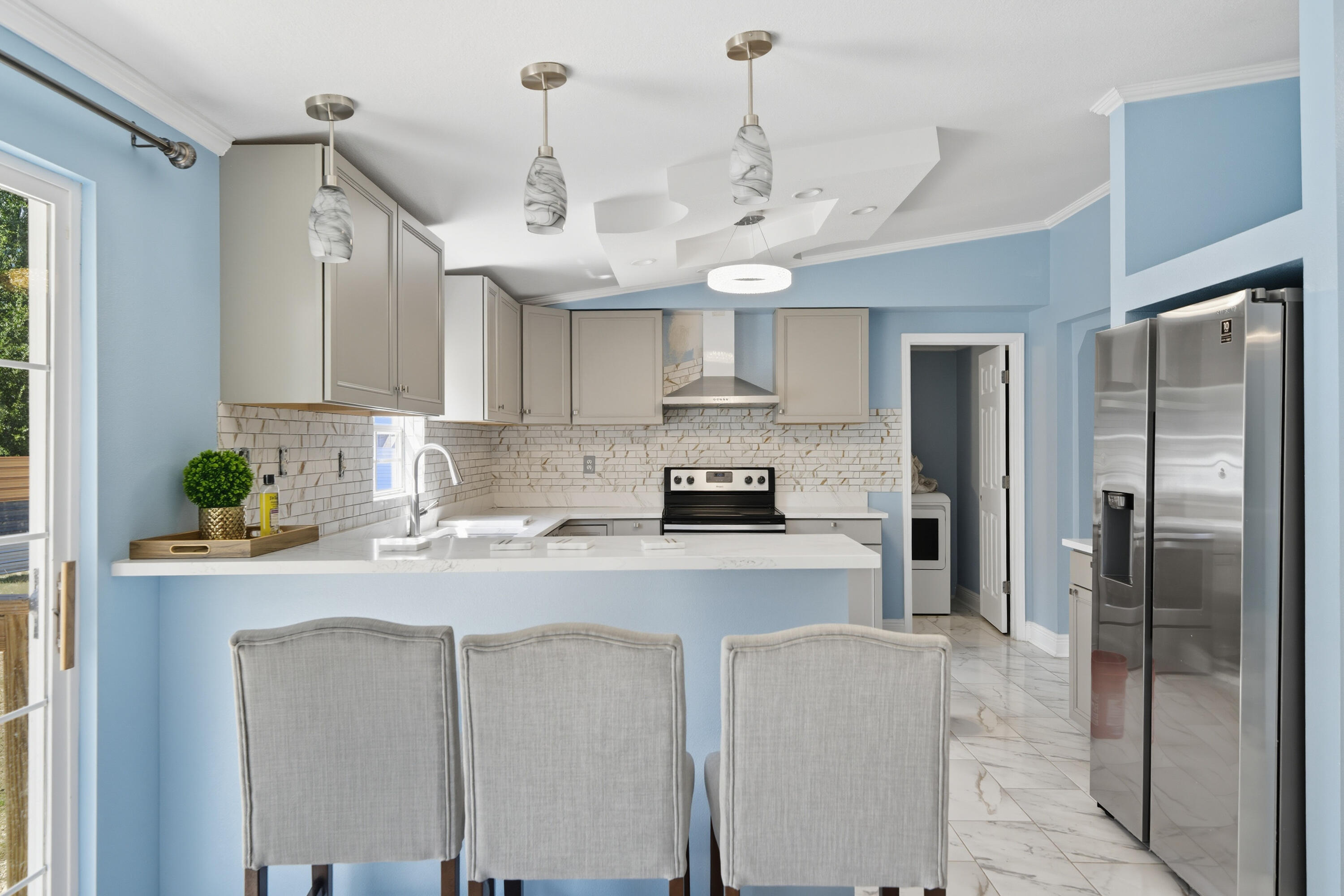 714 East Picasso Road DeFuniak Springs, FL 32433 - Photo 10 of 25 a kitchen with stainless steel appliances granite countertop a sink a stove a refrigerator cabinets and a window