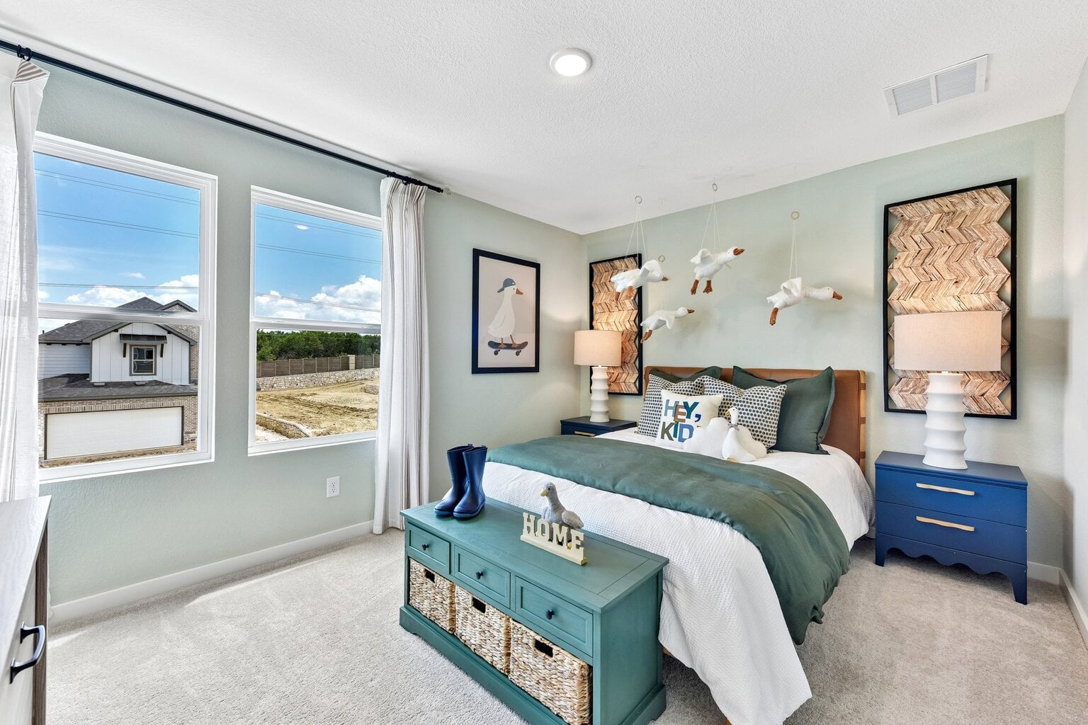 10609 Trifecta Way Buda, TX 78610 - Photo 12 of 17 A well-lit bedroom with two generous windows offers abundant natural light and outdoor views.