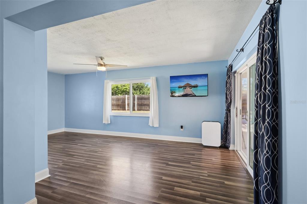 3613 Coppertree Circle Brandon, FL 33511 - Photo 12 of 51 a view of an empty room with wooden floor and a window