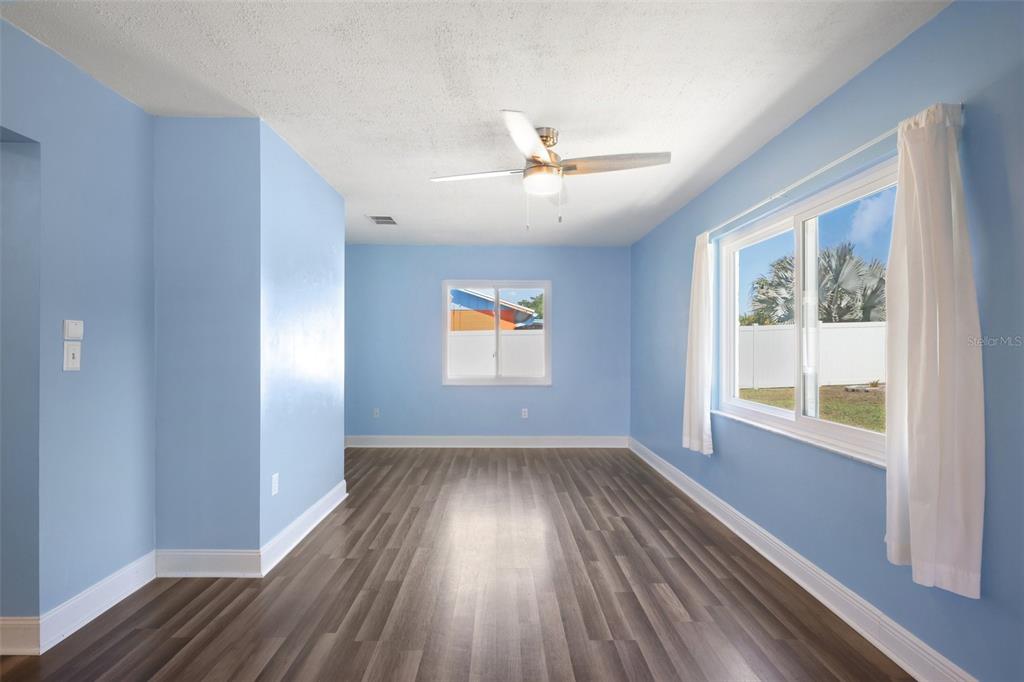 3613 Coppertree Circle Brandon, FL 33511 - Photo 13 of 51 wooden floor in an empty room with a window