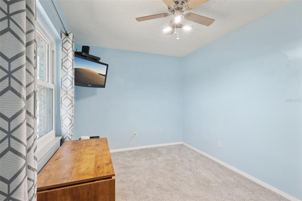 3613 Coppertree Circle Brandon, FL 33511 - Photo 20 of 51 an empty room with windows and ceiling fan