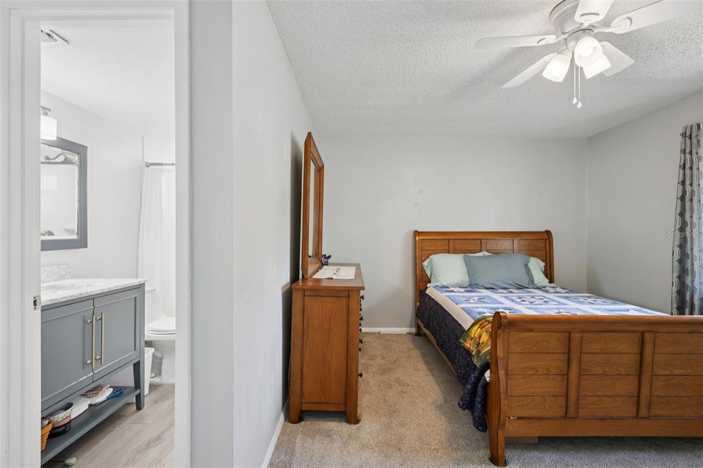 3613 Coppertree Circle Brandon, FL 33511 - Photo 24 of 51 a bedroom with a bed and a chandelier