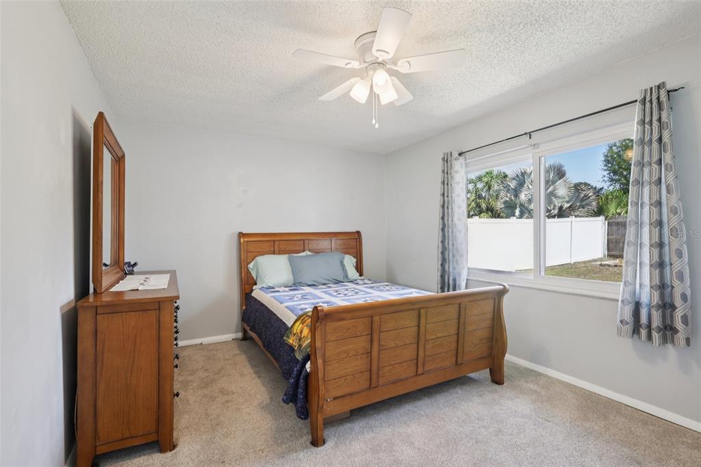 3613 Coppertree Circle Brandon, FL 33511 - Photo 25 of 51 a bedroom with a bed and a chandelier