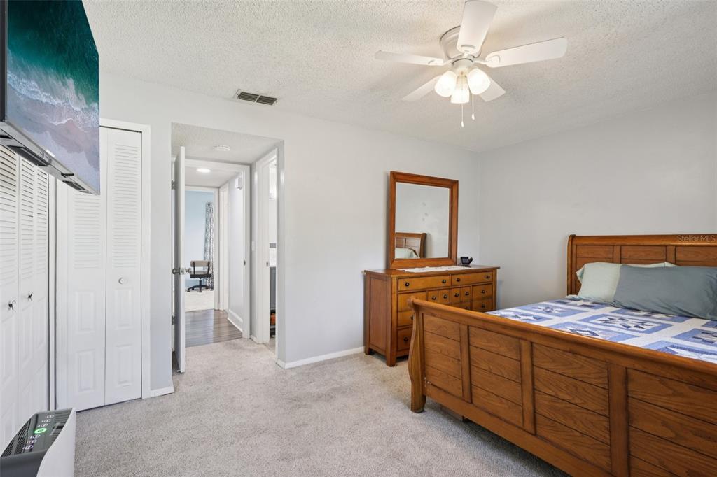 3613 Coppertree Circle Brandon, FL 33511 - Photo 26 of 51 a bedroom with a bed and a chandelier