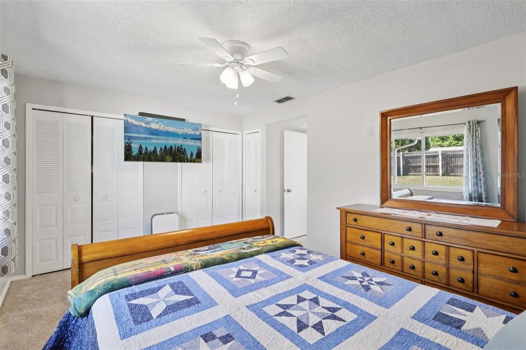 3613 Coppertree Circle Brandon, FL 33511 - Photo 27 of 51 a bedroom with a bed and a lamp on dresser
