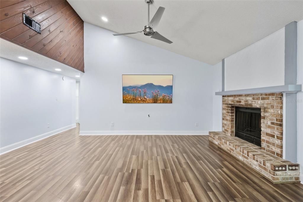 3613 Coppertree Circle Brandon, FL 33511 - Photo 5 of 51 a view of an empty room with wooden floor fireplace and a window