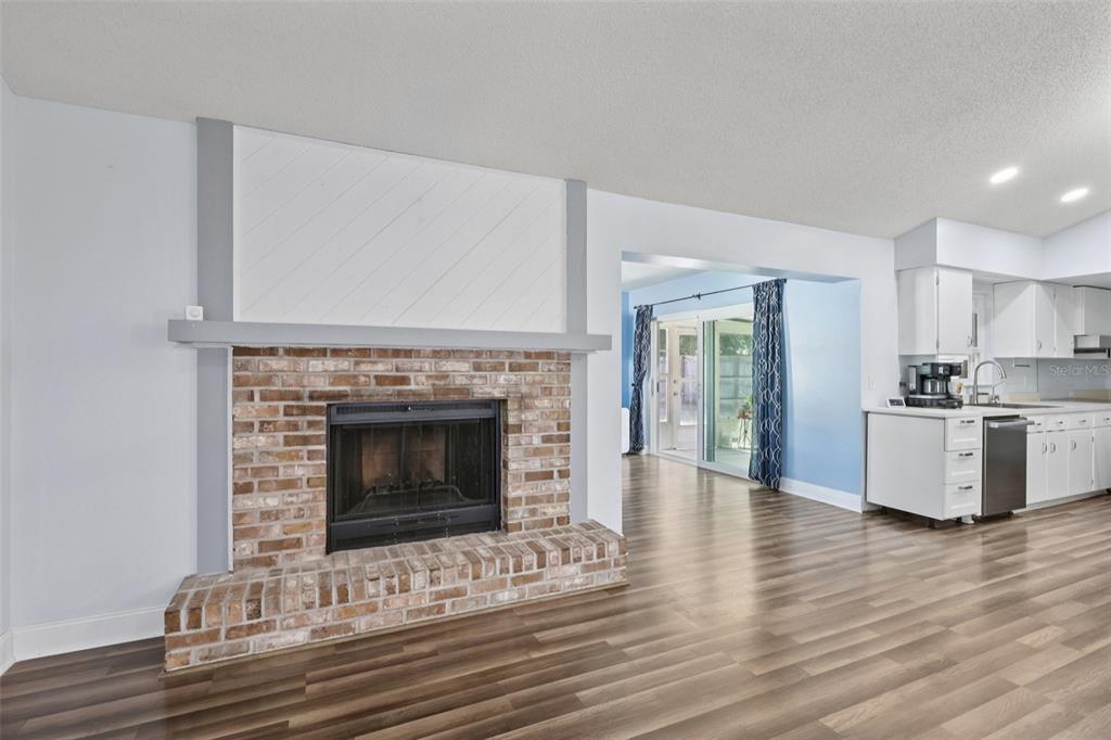 3613 Coppertree Circle Brandon, FL 33511 - Photo 7 of 51 a living room with a fireplace and wooden floor
