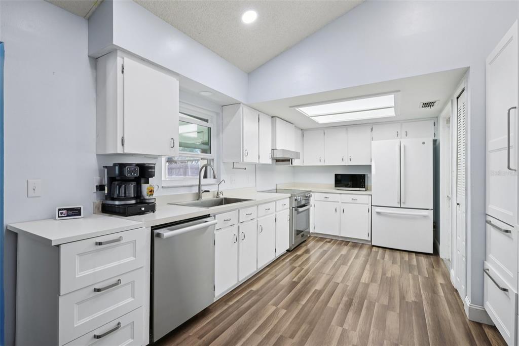 3613 Coppertree Circle Brandon, FL 33511 - Photo 9 of 51 a kitchen with white cabinets sink and white appliances