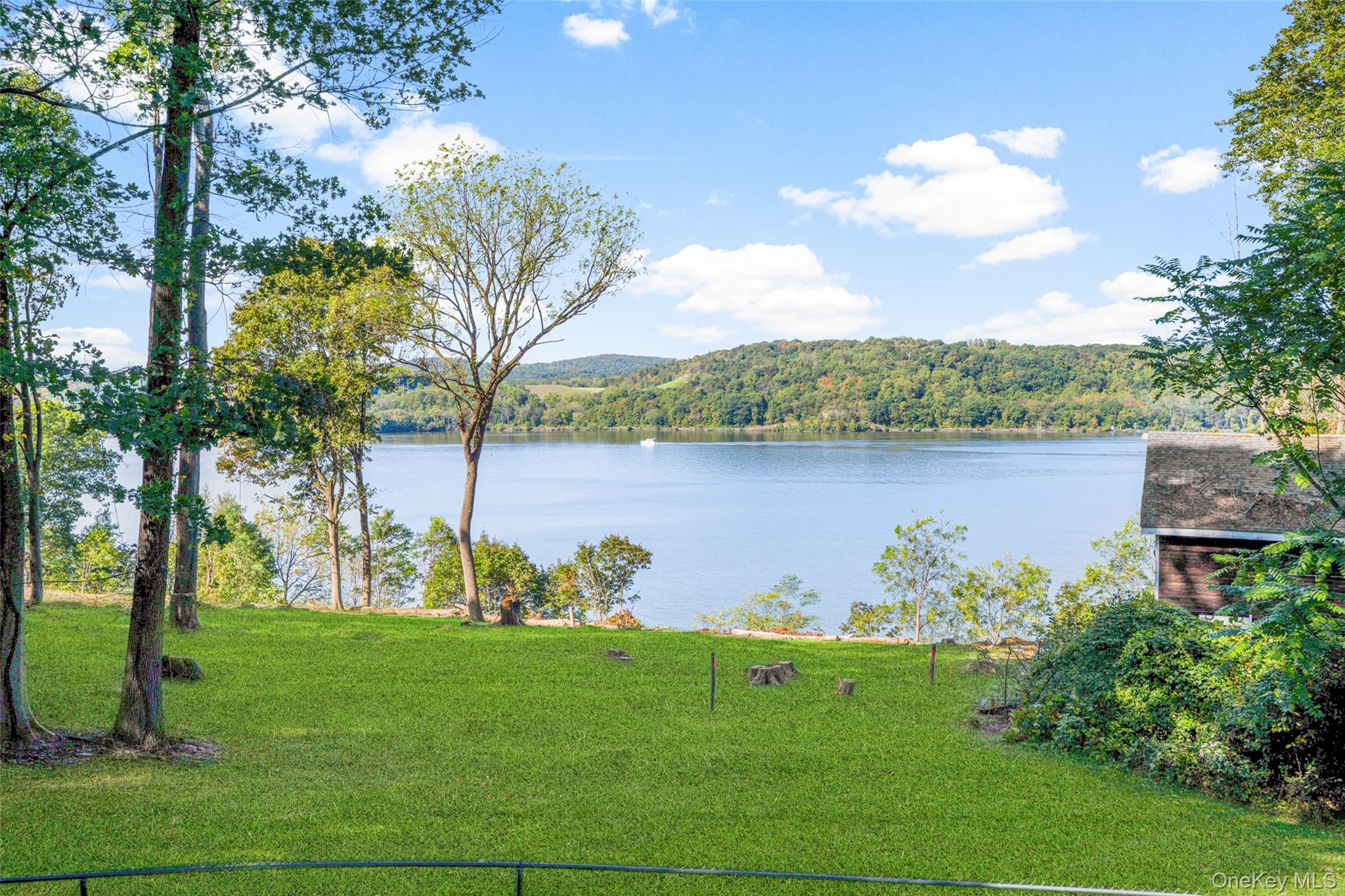 660 Wheeler Hill Road Wappingers Falls, NY 12590 - Photo 19 of 32 a view of a lake with a house in the background