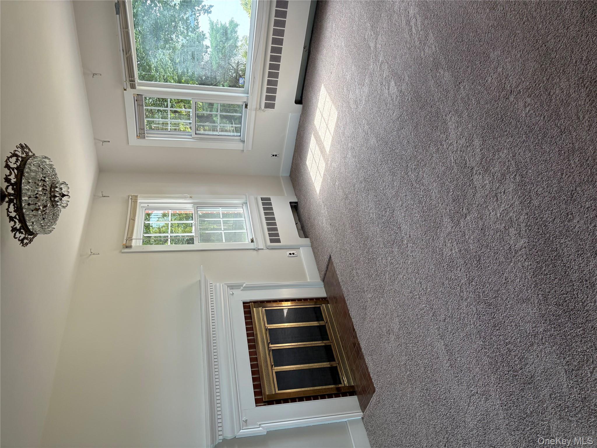 660 Wheeler Hill Road Wappingers Falls, NY 12590 - Photo 10 of 32 a view of an empty room with a fireplace and large windows