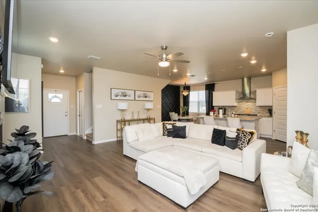 a living room with furniture and kitchen view