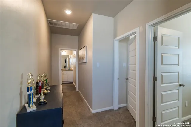 a view of a hallway with closet and a livingroom view