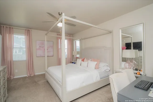 a bedroom with a bed couch and window