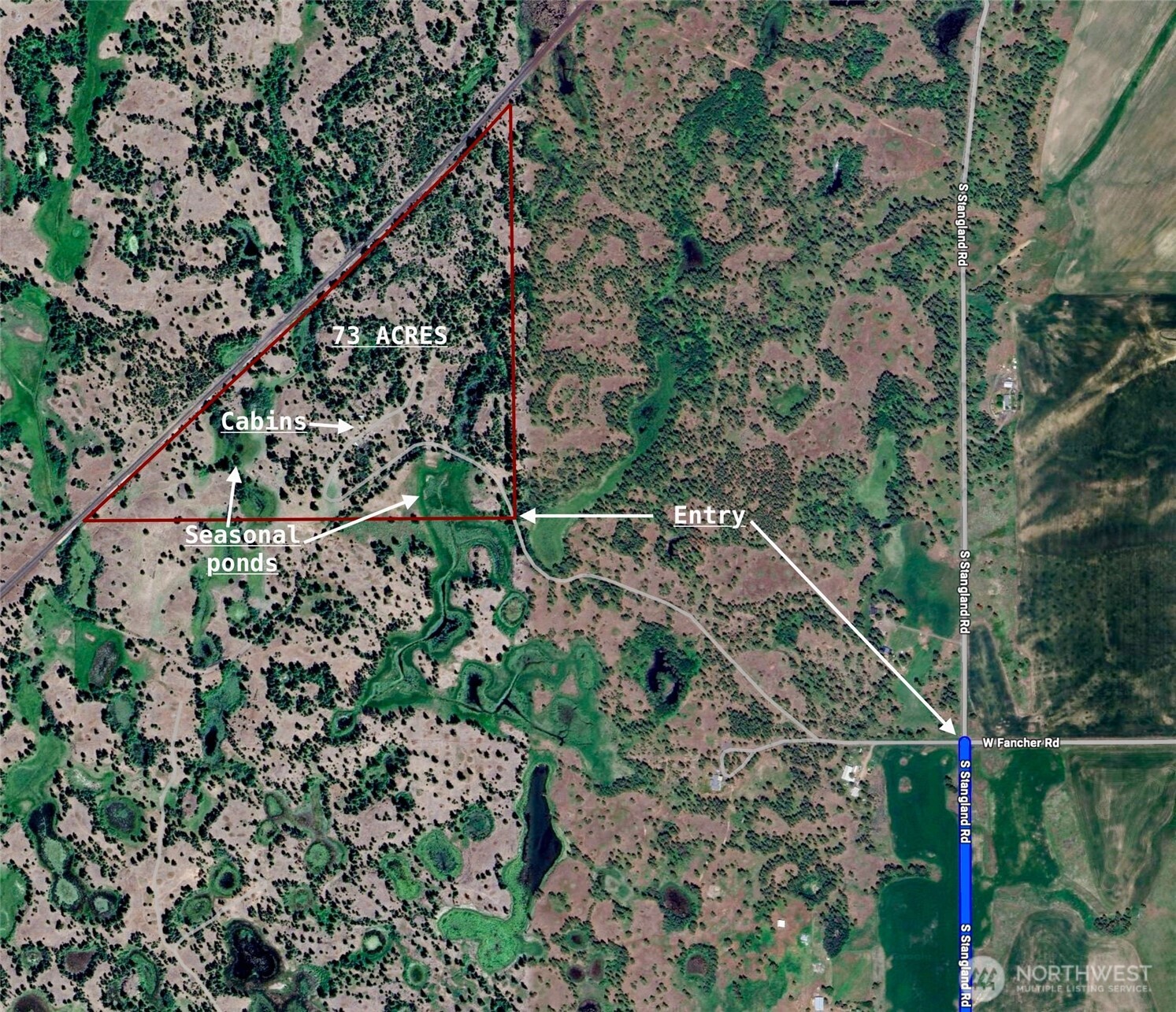 11300 South Stangland Road Medical Lake, WA 99022 - Photo 2 of 27 a view of a yard with a tree