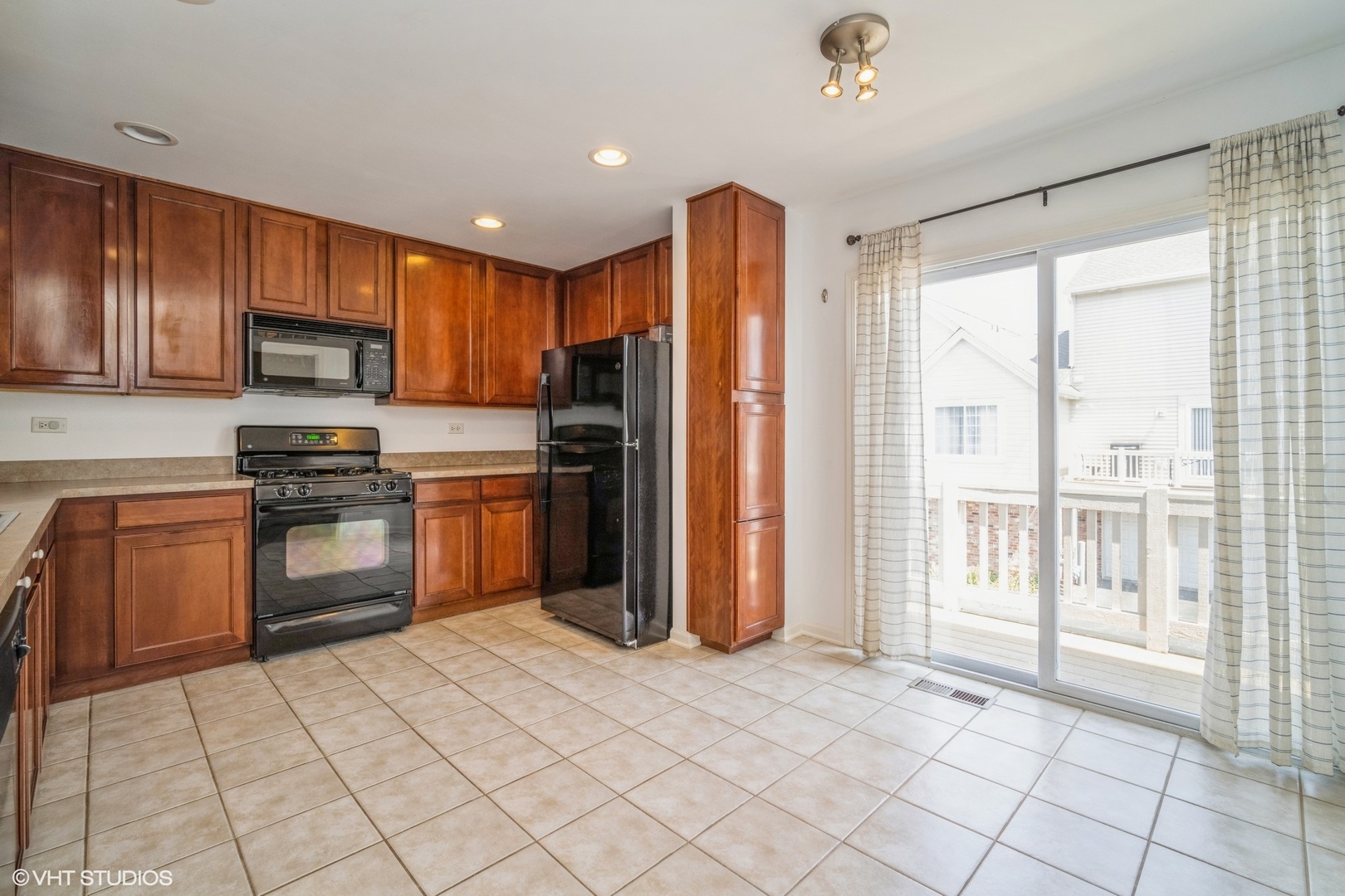 3388 Sanctuary Drive Elgin, IL 60124 - Photo 3 of 15 a kitchen with stainless steel appliances granite countertop a refrigerator oven a sink dishwasher and white cabinets with wooden floor