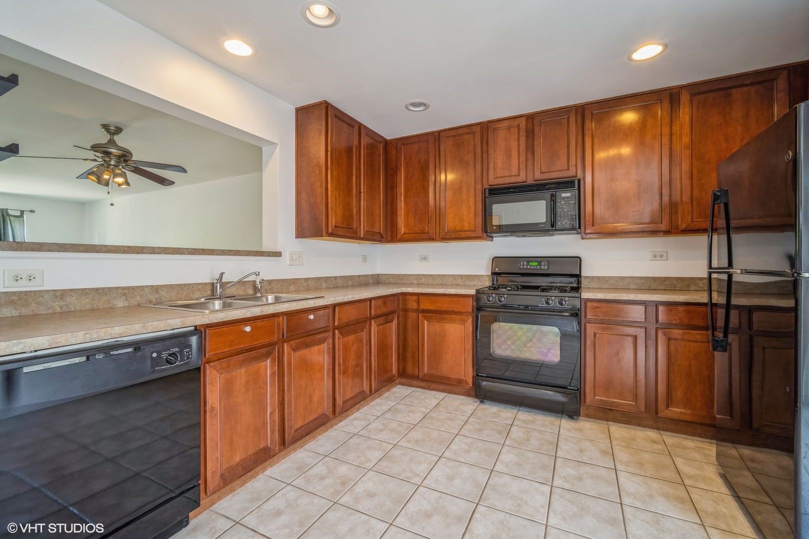 3388 Sanctuary Drive Elgin, IL 60124 - Photo 4 of 15 a kitchen with stainless steel appliances granite countertop a stove microwave and sink