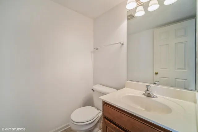 a bathroom with a sink a toilet and vanity