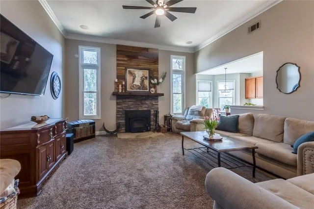 a living room with furniture a flat screen tv and a fireplace