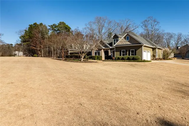 a view of a house with a yard covered in snow