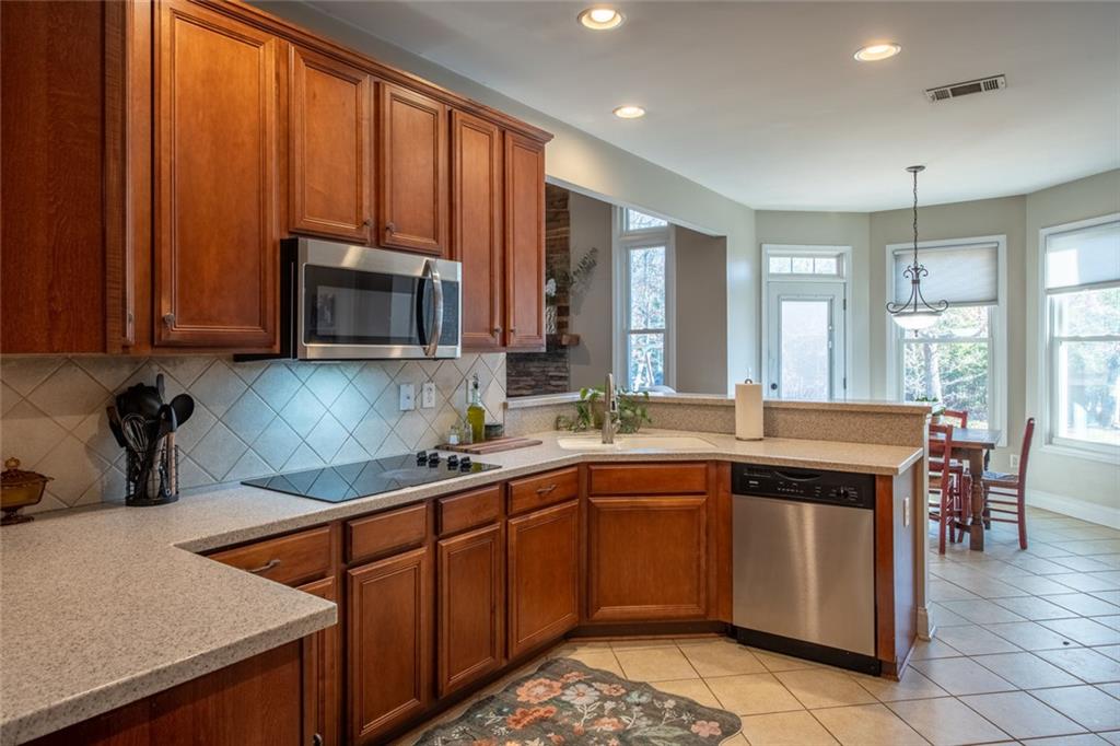 8620 Copperridge Drive Winston, GA 30187 - Photo 31 of 45 a kitchen with stainless steel appliances granite countertop wooden cabinets a sink and a stove