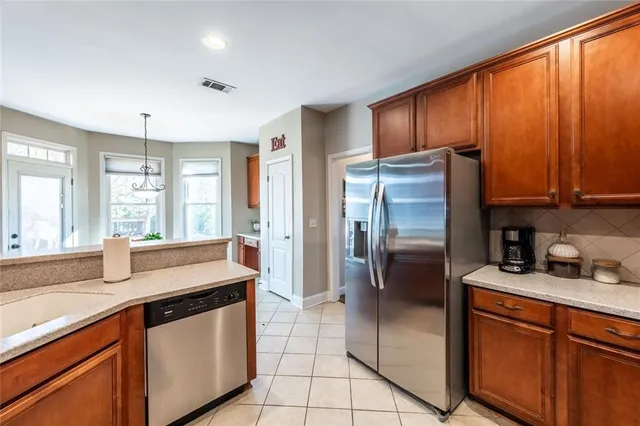 a kitchen with stainless steel appliances granite countertop a refrigerator and a sink