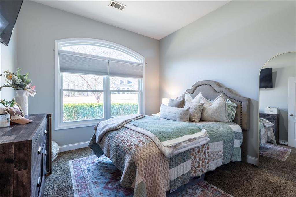 8620 Copperridge Drive Winston, GA 30187 - Photo 36 of 45 a bedroom with a bed and a flat tv screen on dresser