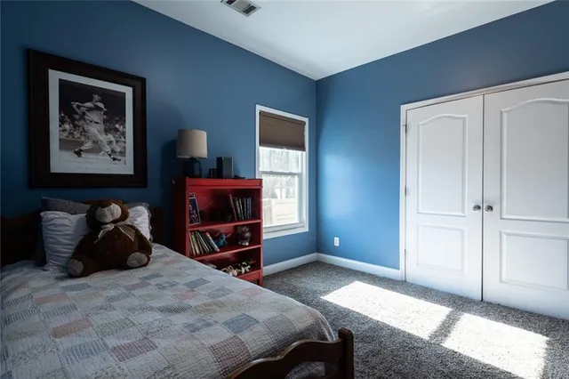 a bedroom with a bed and a closet