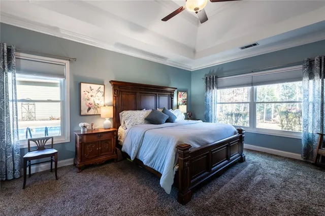 a spacious bedroom with a bed and a window