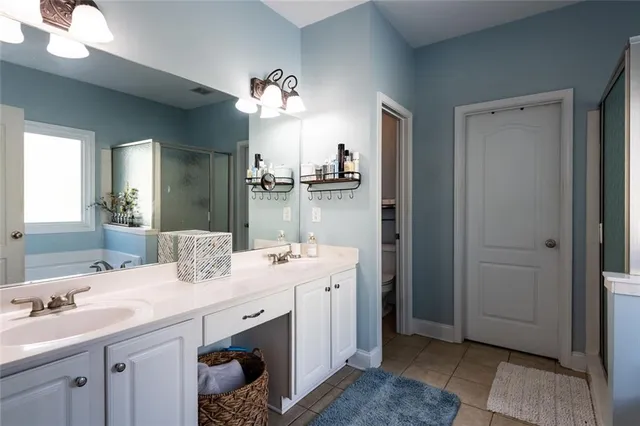a bathroom with a double vanity sink and a mirror