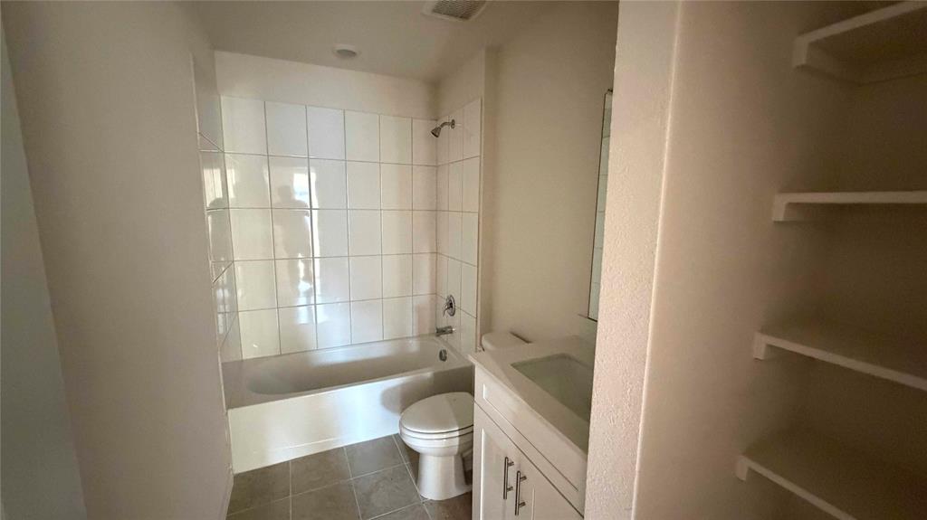 1550 Brooke Drive Tyler, TX 75704 - Photo 9 of 17 a bathroom with a granite countertop toilet and a shower