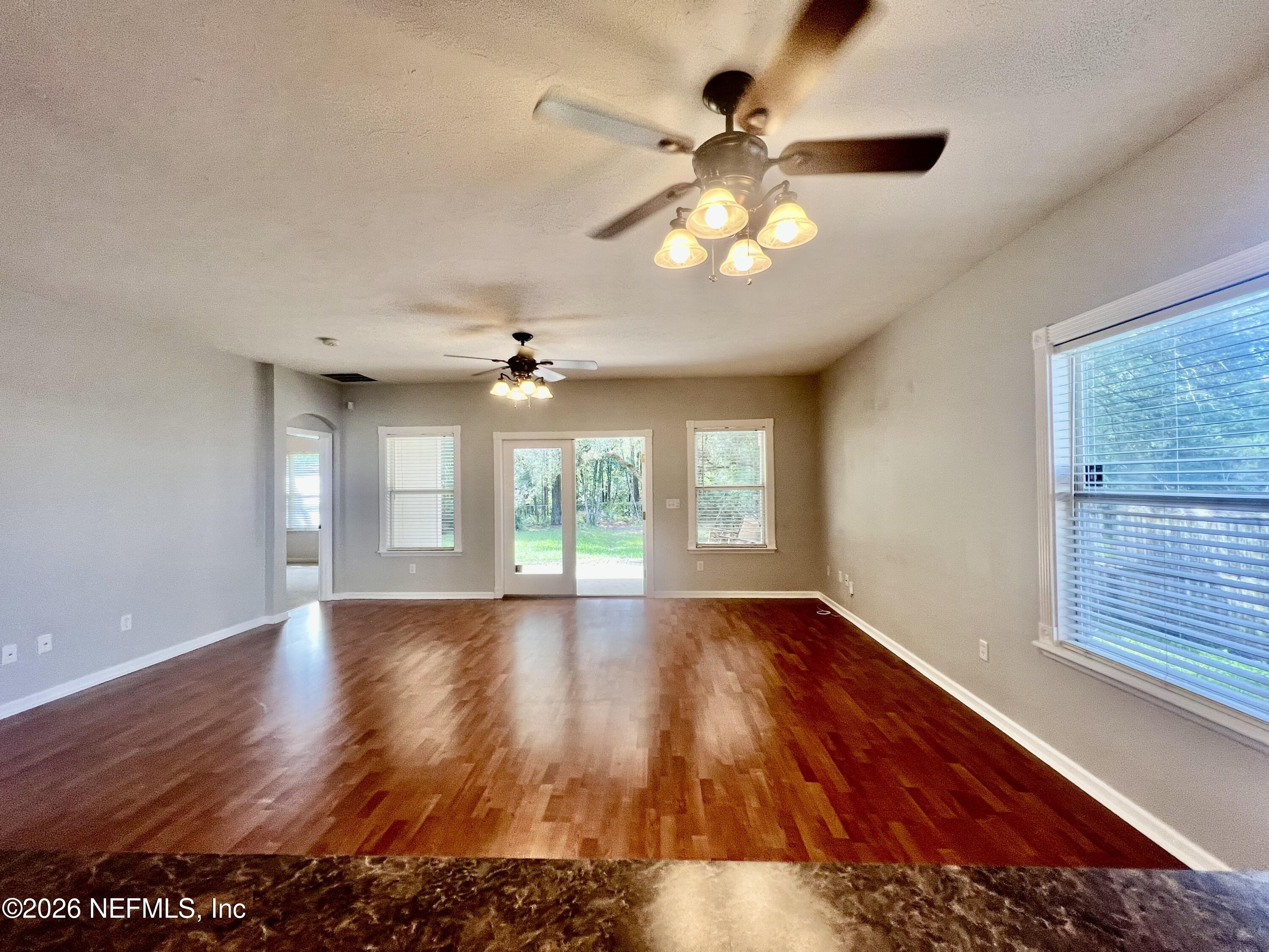 5410 Turkey Creek Road Jacksonville, FL 32244 - Photo 19 of 48 a view of an empty room with wooden floor and a window