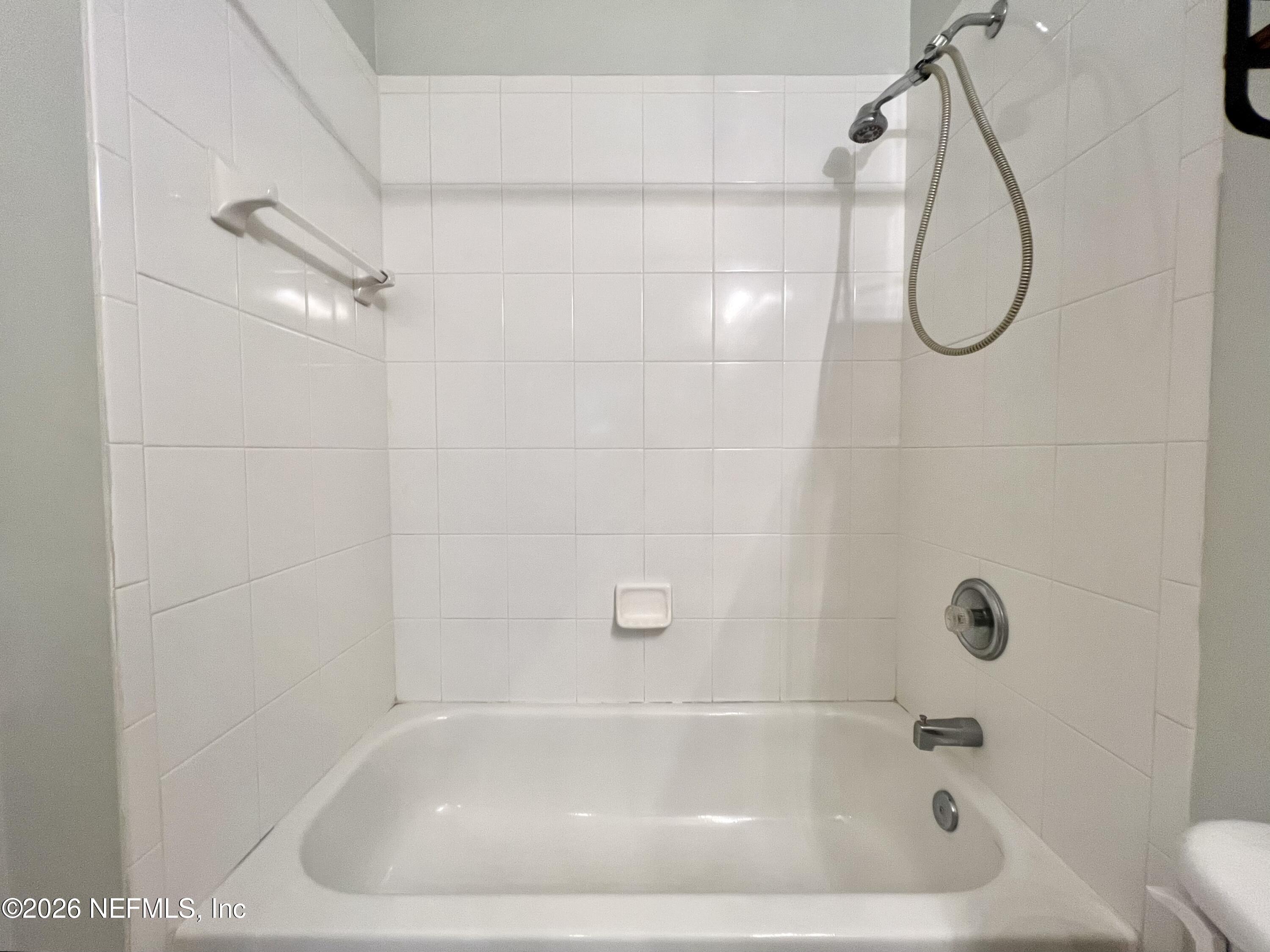 5410 Turkey Creek Road Jacksonville, FL 32244 - Photo 28 of 48 a bathroom with a bath tub with a shower