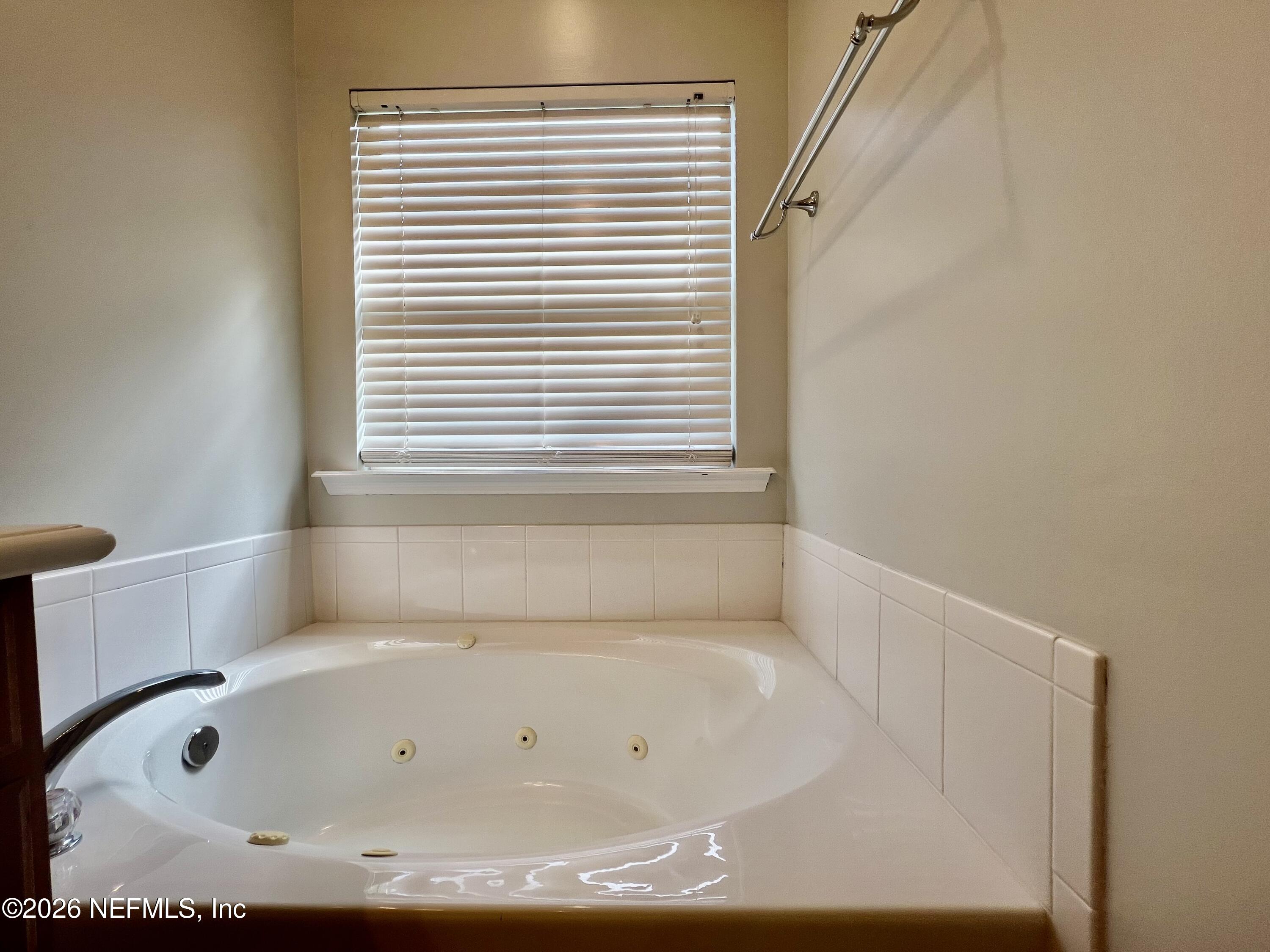 5410 Turkey Creek Road Jacksonville, FL 32244 - Photo 38 of 48 a bathroom with bathtub and window