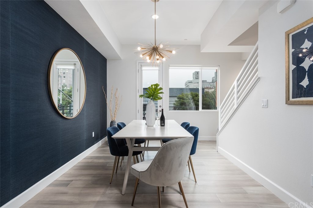 201 Elm Avenue Long Beach, CA 90802 - Photo 2 of 23 a dining room with chandelier and wooden floor