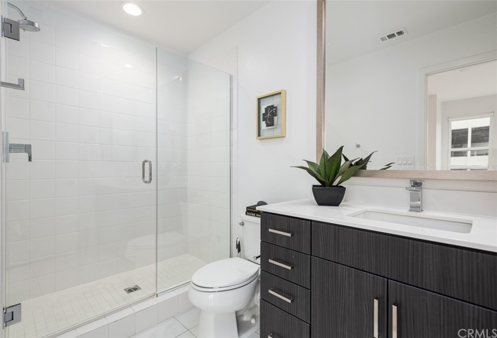 201 Elm Avenue Long Beach, CA 90802 - Photo 11 of 23 a bathroom with a sink a toilet and shower