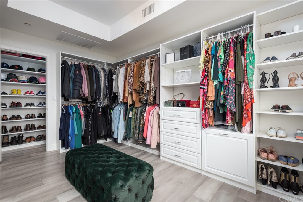 201 Elm Avenue Long Beach, CA 90802 - Photo 12 of 23 a view of walk in closet with clothes and shoes