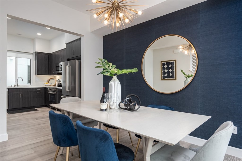 201 Elm Avenue Long Beach, CA 90802 - Photo 3 of 23 a kitchen with a table chairs and a refrigerator