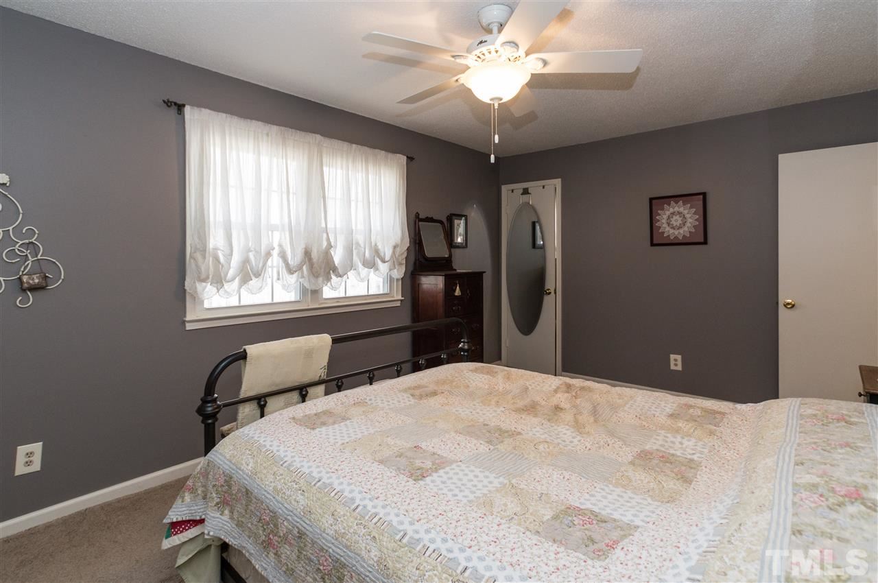 1108 Mockingbird Drive Raleigh, NC 27615 - Photo 12 of 21 a bedroom with a bed and a window