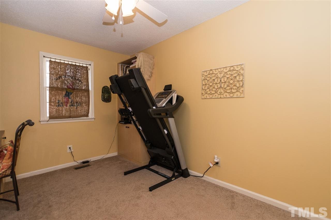 1108 Mockingbird Drive Raleigh, NC 27615 - Photo 13 of 21 a room with gym equipment and windows