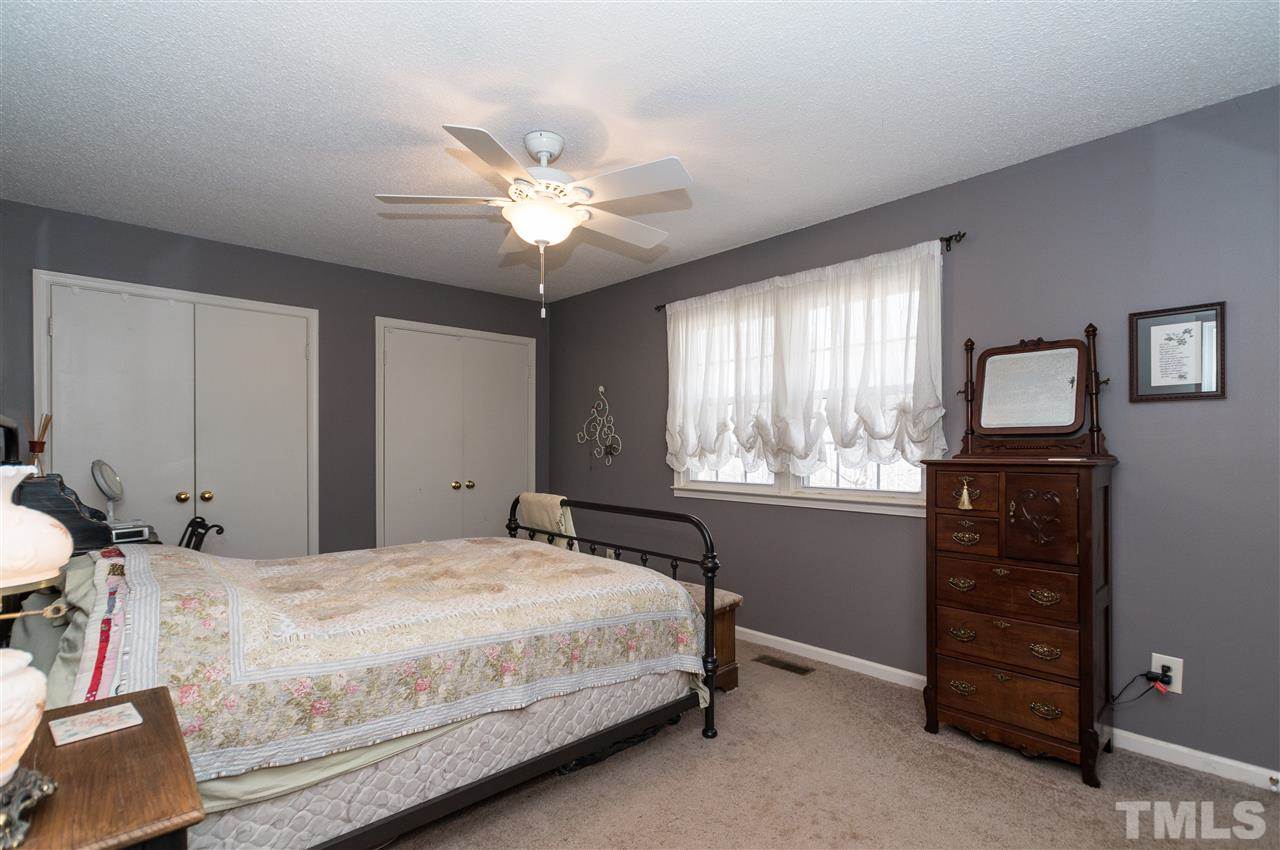 1108 Mockingbird Drive Raleigh, NC 27615 - Photo 10 of 21 a bedroom with a bed and a tv on dresser