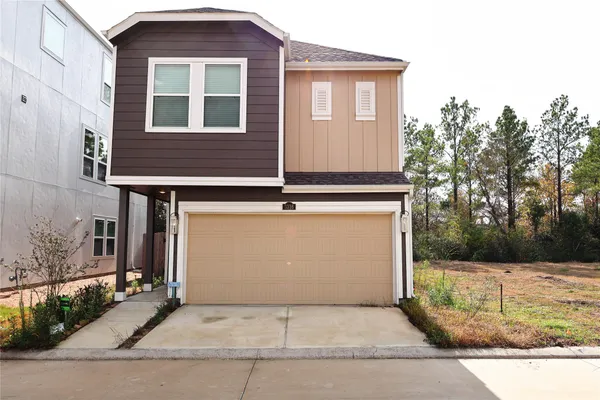 a front view of a house with garage