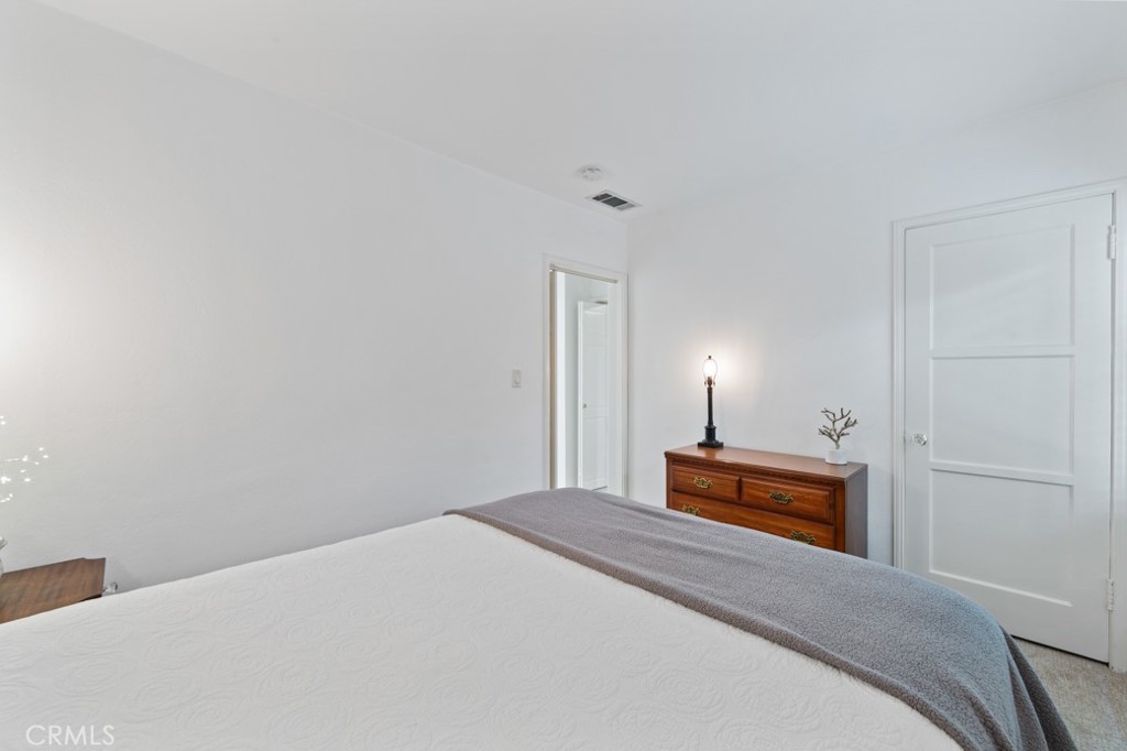 4425 Walnut Avenue Long Beach, CA 90807 - Photo 11 of 50 a bedroom with a bed and a lamp