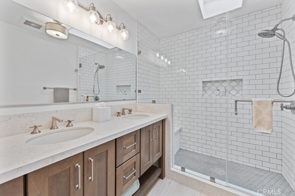 4425 Walnut Avenue Long Beach, CA 90807 - Photo 15 of 50 a bathroom with a sink double vanity and shower